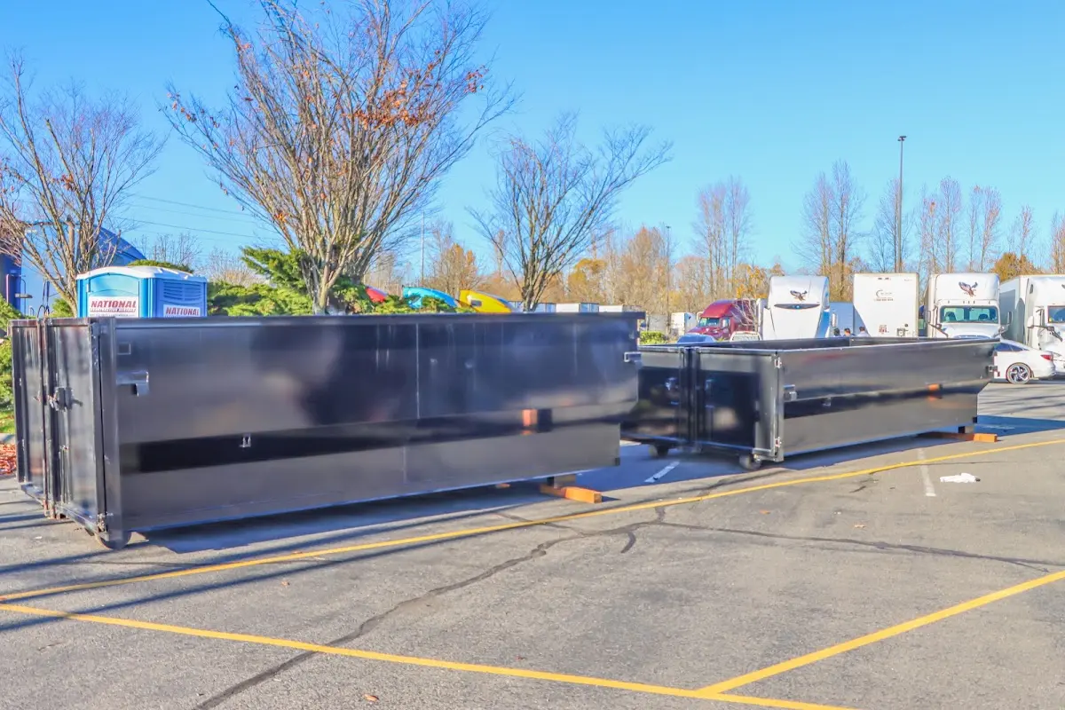 Professional dumpster rental service with roll-off container on residential driveway in Lyon